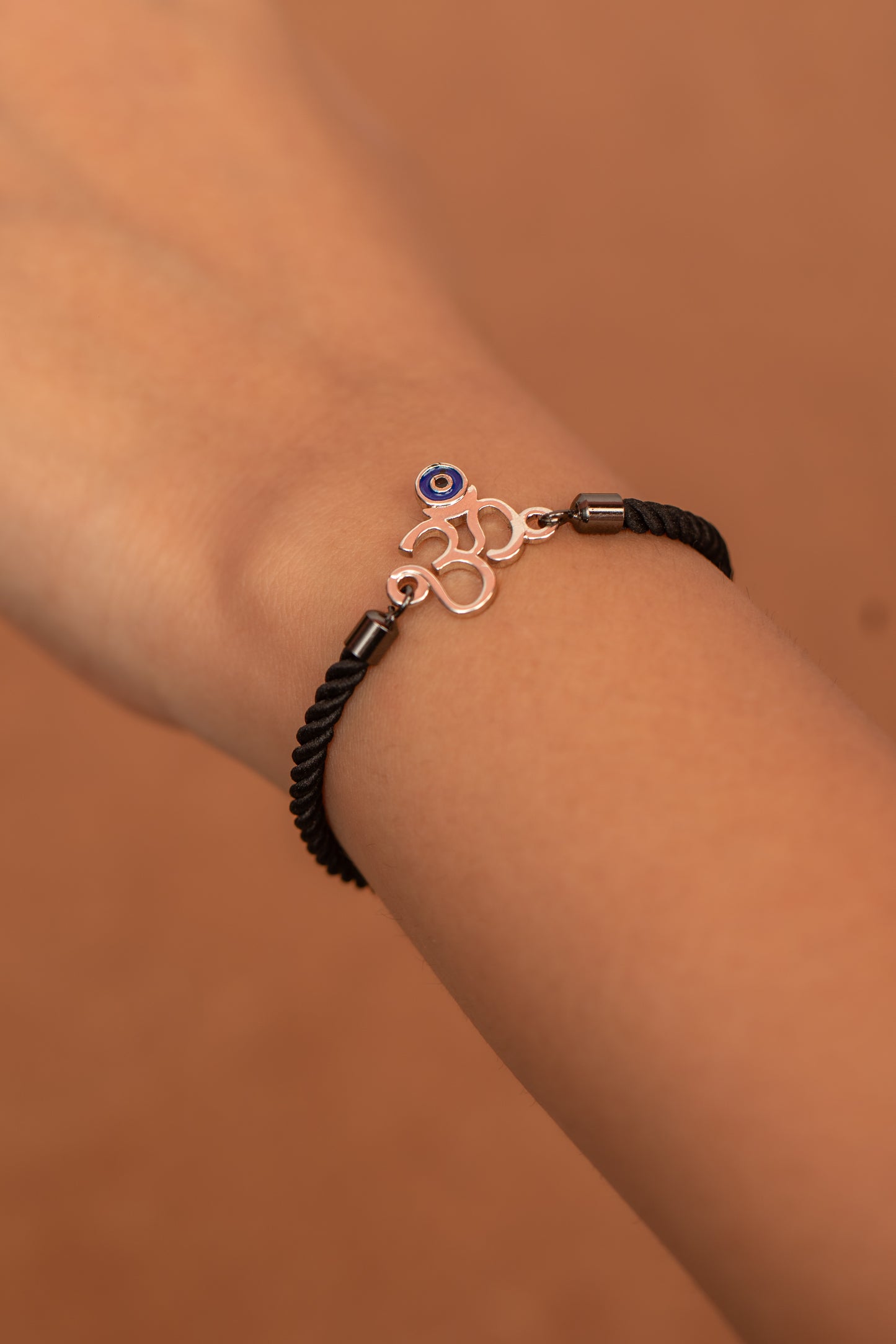 OM WITH EVIL EYE IN SILVER POLISH